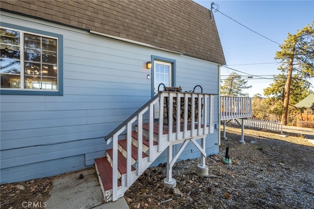 view of exterior entry featuring a wooden deck