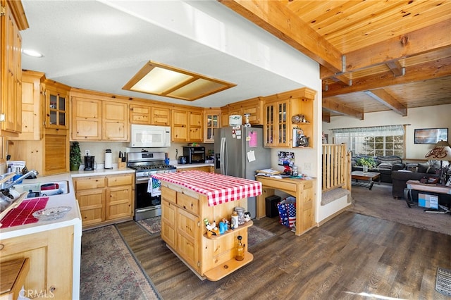 kitchen with appliances with stainless steel finishes, beamed ceiling, dark wood-type flooring, a kitchen island, and sink