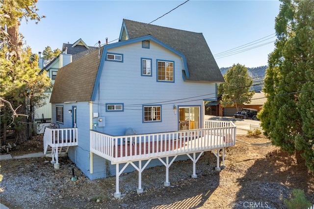 rear view of house featuring a deck