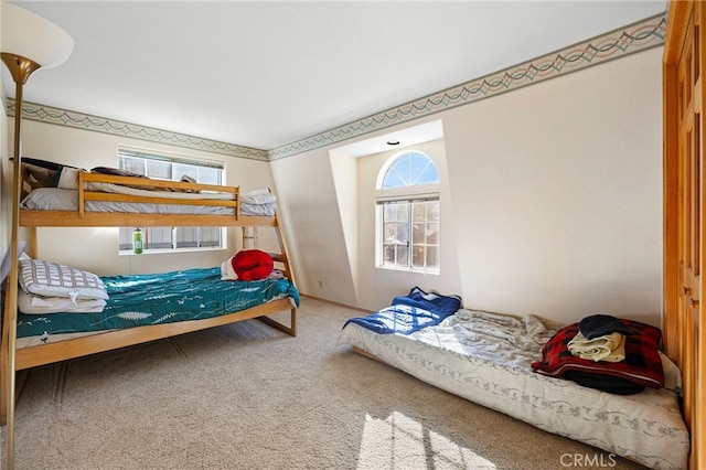 carpeted bedroom featuring multiple windows