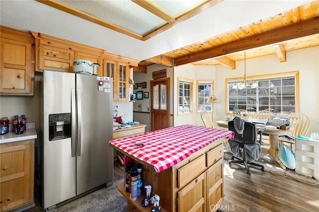 kitchen with decorative light fixtures, beam ceiling, stainless steel refrigerator with ice dispenser, an inviting chandelier, and dark hardwood / wood-style flooring