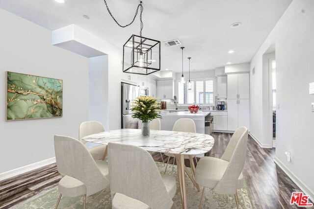 dining area with dark hardwood / wood-style flooring