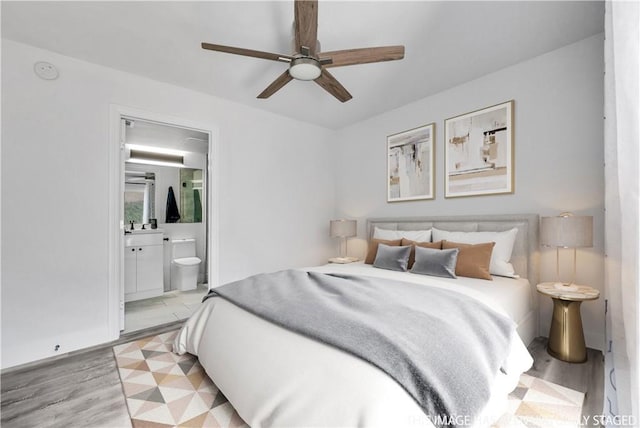 bedroom with ceiling fan, sink, ensuite bathroom, and light hardwood / wood-style flooring