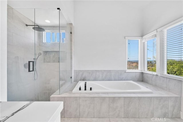 bathroom with shower with separate bathtub