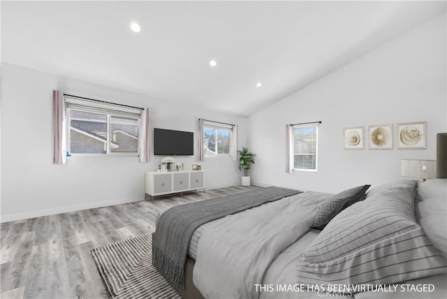 bedroom featuring vaulted ceiling and light hardwood / wood-style flooring