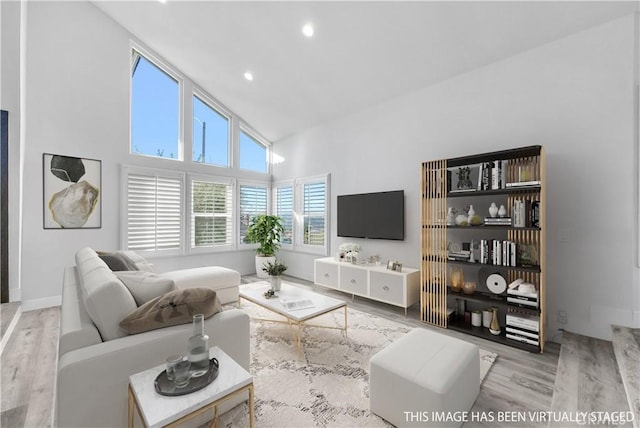 living room with vaulted ceiling and light hardwood / wood-style flooring