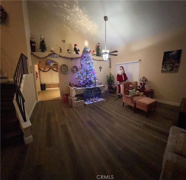 living room with ceiling fan and dark hardwood / wood-style floors