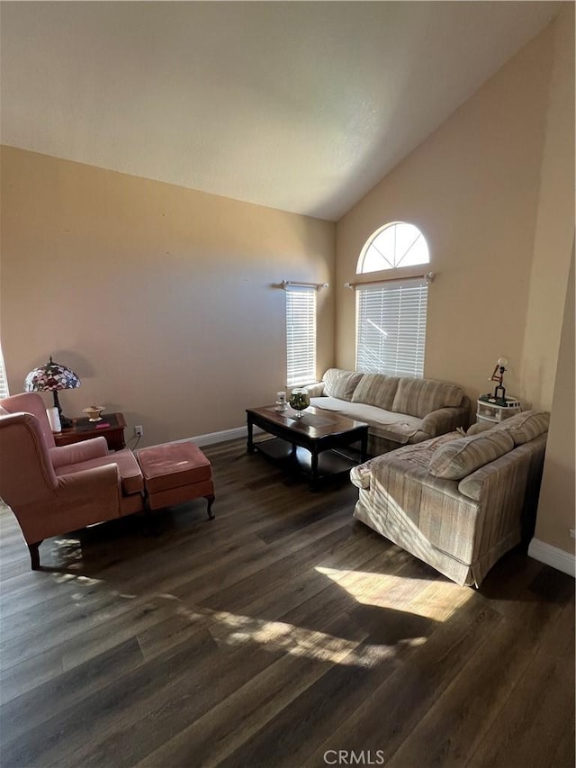 living area featuring dark wood-type flooring, high vaulted ceiling, and baseboards