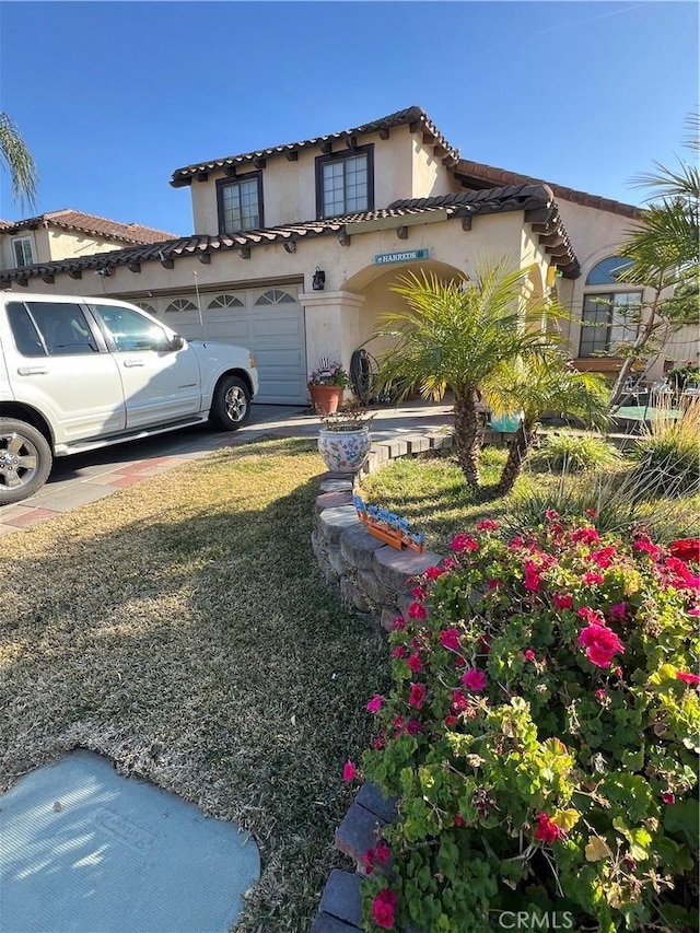 mediterranean / spanish-style house with a garage