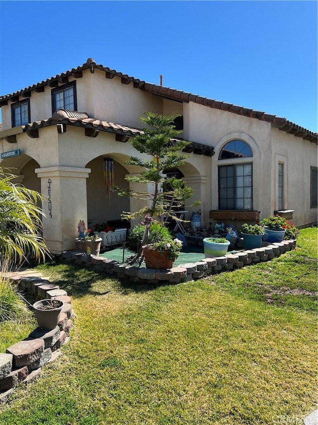 view of front of property with a front yard and stucco siding