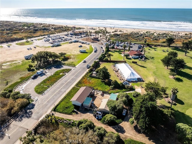 bird's eye view featuring a water view and a view of the beach