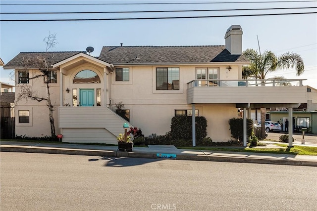 view of front of property featuring a balcony