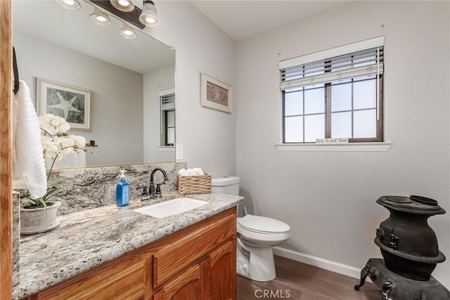 bathroom featuring toilet and vanity