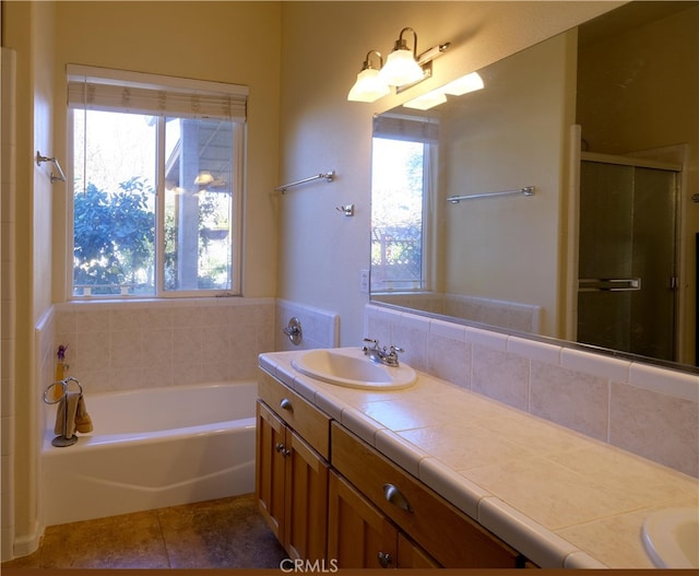 bathroom featuring vanity, independent shower and bath, and tile patterned flooring