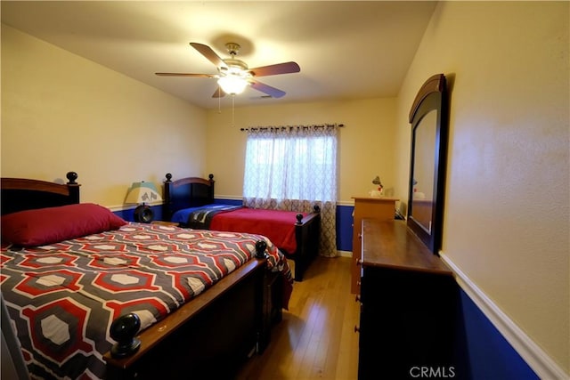 bedroom featuring hardwood / wood-style flooring and ceiling fan