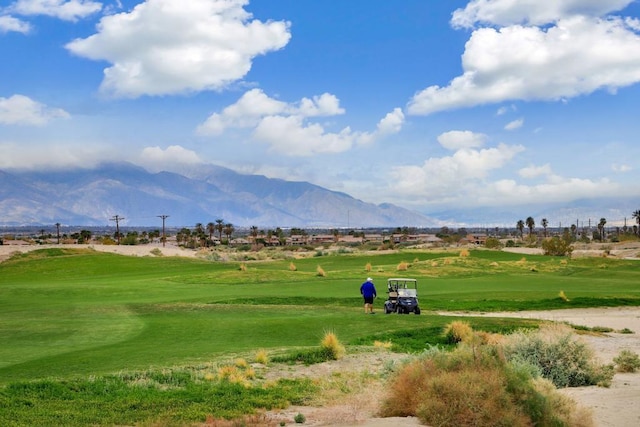 view of property's community featuring a mountain view and a lawn