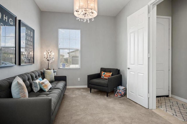 living room with light carpet and a notable chandelier