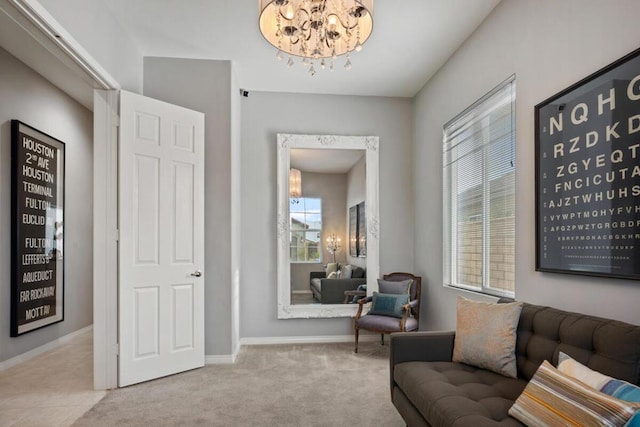 living area featuring an inviting chandelier, a healthy amount of sunlight, and light colored carpet