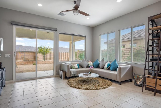 interior space featuring ceiling fan and a mountain view