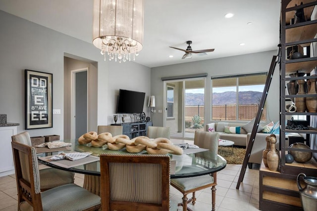 tiled dining space with ceiling fan with notable chandelier