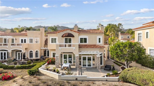 back of property featuring french doors and a patio area