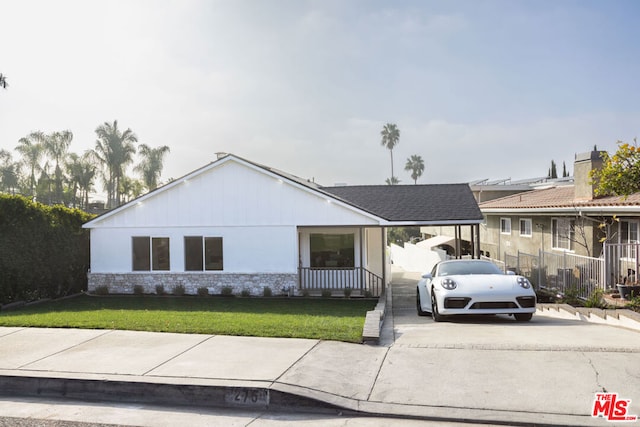 view of front of property with a front lawn and a carport