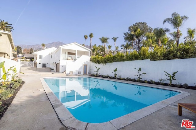 view of swimming pool with a mountain view