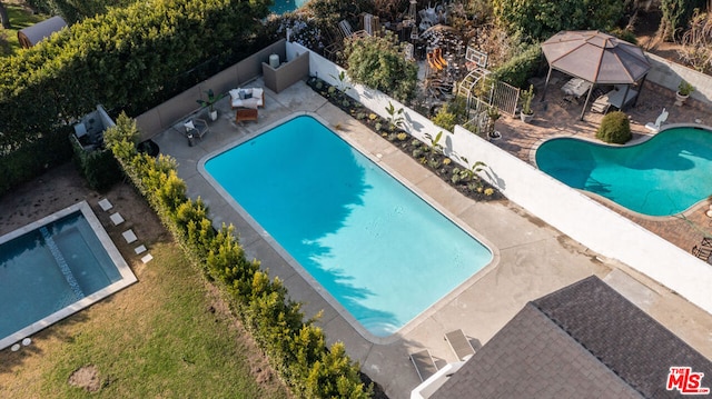 view of pool featuring a gazebo and a jacuzzi