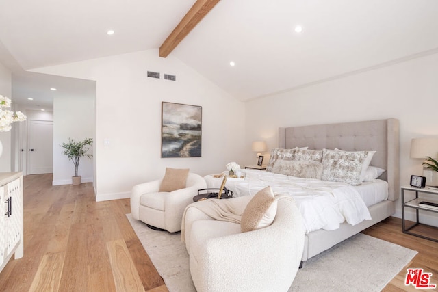 bedroom with light hardwood / wood-style flooring and lofted ceiling with beams