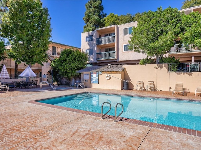 view of swimming pool with a patio area