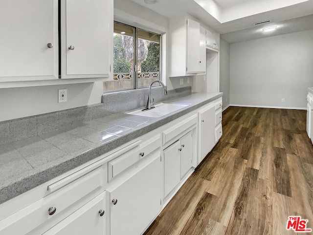 kitchen with white cabinetry, sink, and dark wood-type flooring