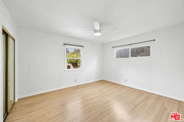 unfurnished bedroom featuring a closet, light hardwood / wood-style floors, and ceiling fan