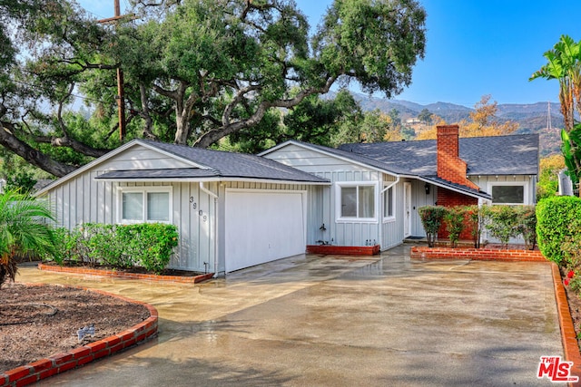 single story home with a mountain view and a garage