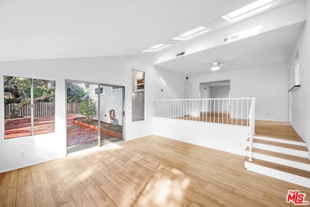 empty room featuring hardwood / wood-style floors, ceiling fan, and vaulted ceiling