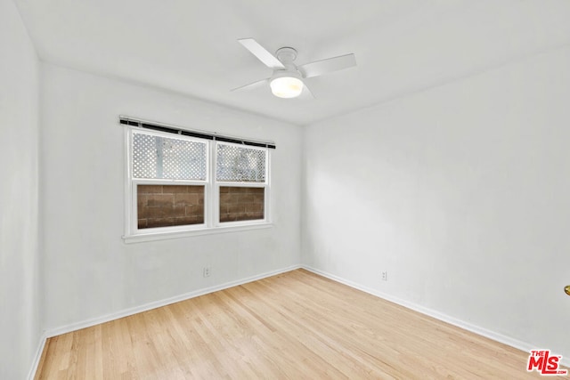 empty room with light wood-type flooring and ceiling fan