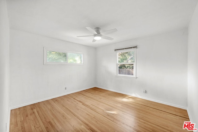 unfurnished room featuring ceiling fan and light wood-type flooring