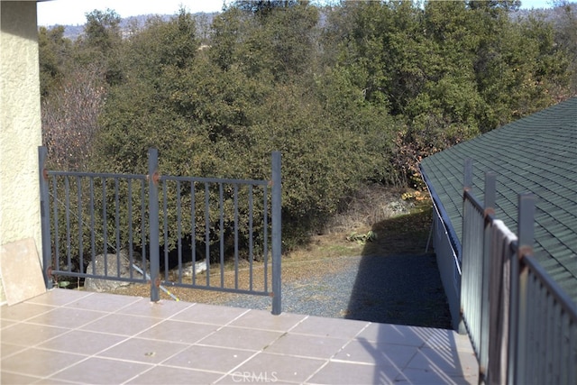 view of gate featuring a patio area