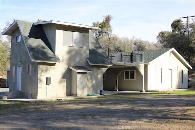 back of house with a wooden deck