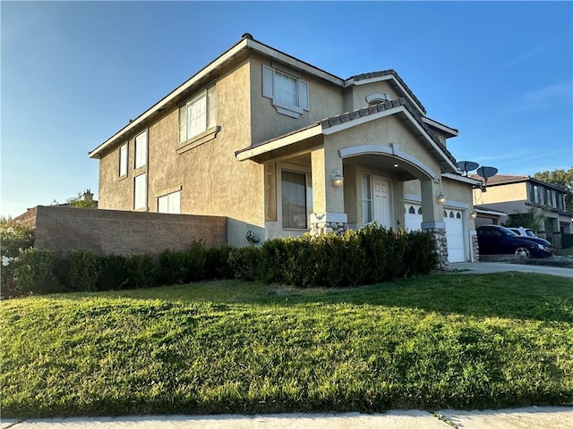 view of front of home with a front lawn and a garage