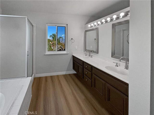 bathroom with vanity, hardwood / wood-style floors, and separate shower and tub