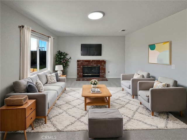 living room featuring a brick fireplace