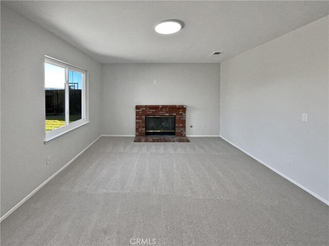 unfurnished living room with a fireplace and carpet floors