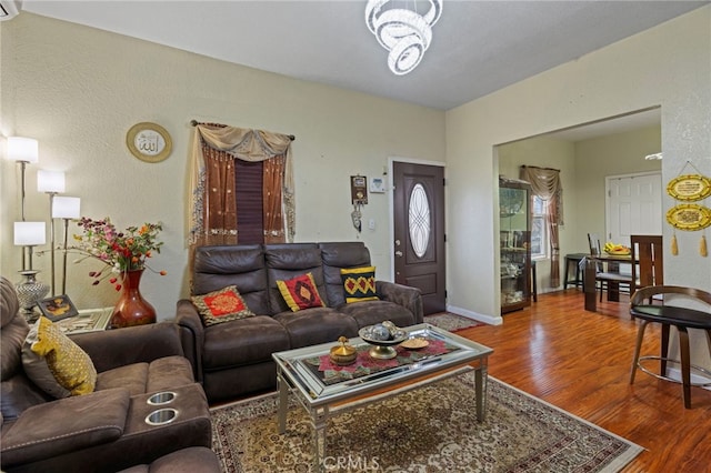 living room featuring hardwood / wood-style flooring and a chandelier