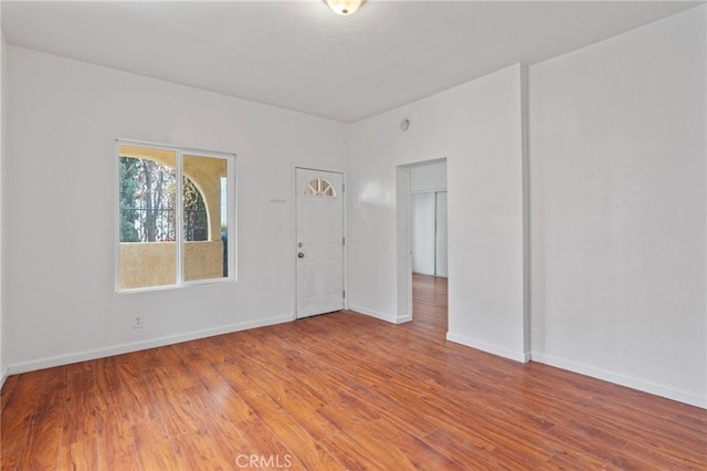 unfurnished room with hardwood / wood-style flooring