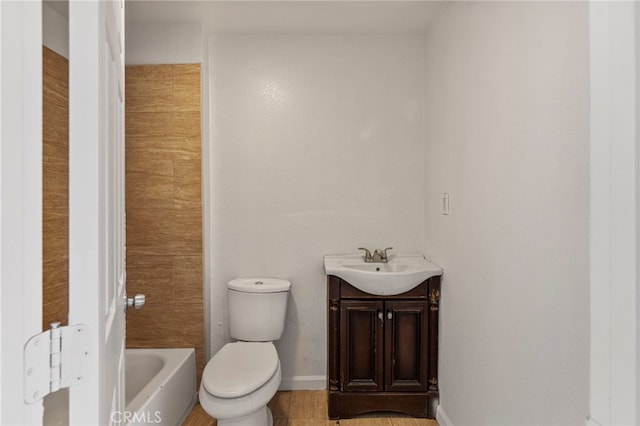 bathroom with vanity, a washtub, and toilet