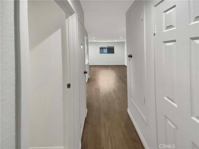 hall with dark hardwood / wood-style flooring