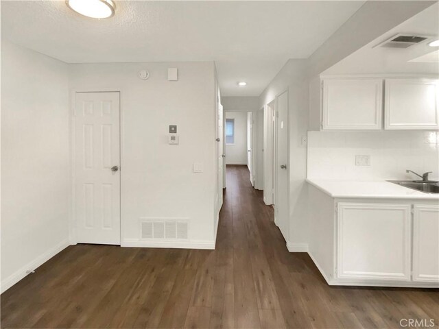 hall featuring dark hardwood / wood-style flooring and sink