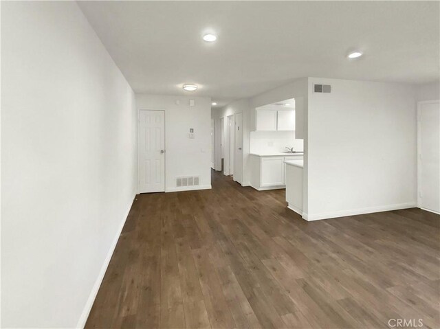 unfurnished living room with dark hardwood / wood-style flooring