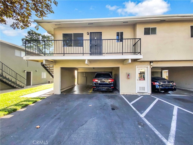townhome / multi-family property featuring stairs and stucco siding
