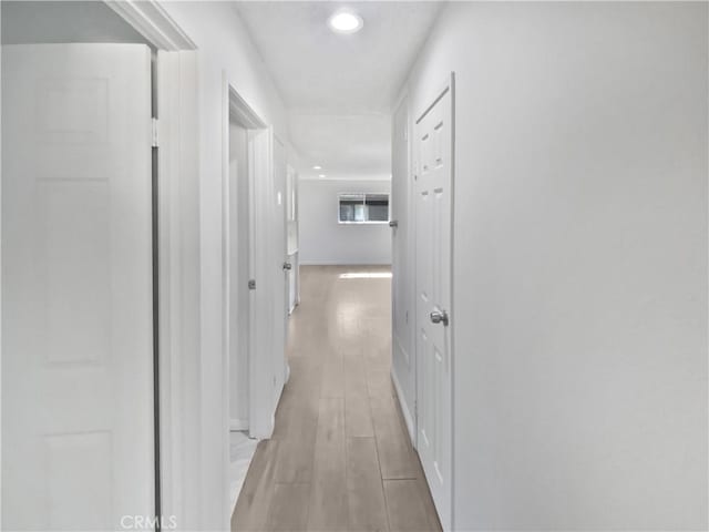 1307 W 8th St, Upland, CA 91786 - hallway featuring recessed lighting, light wood-style flooring, and baseboards